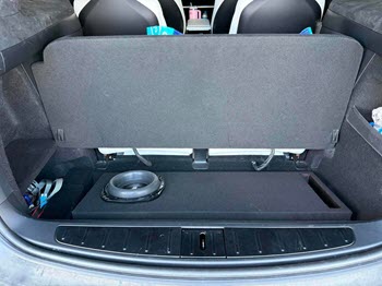 Custom subwoofer enclosure installed in vehicle trunk